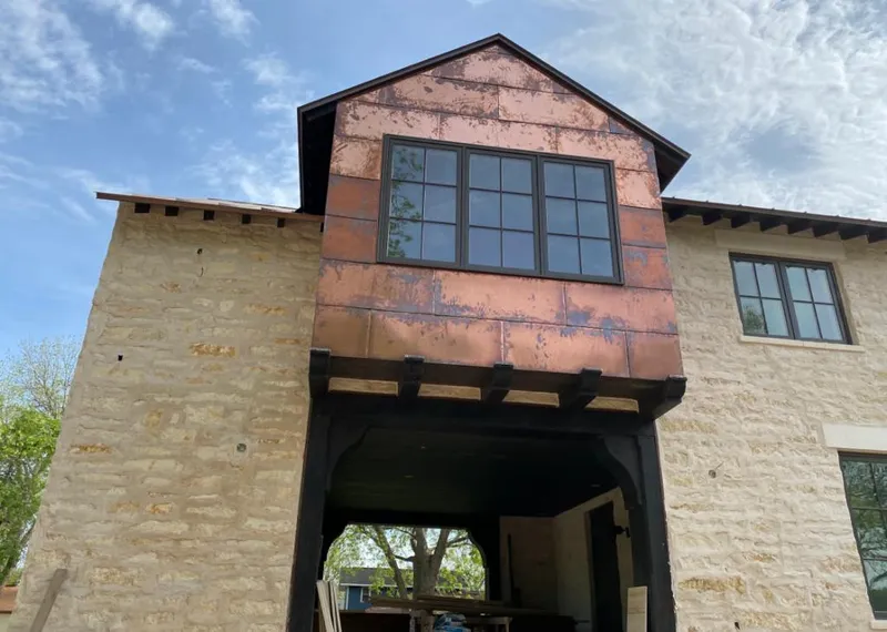 Copper metal panel facade on a stone building for Roof Repair in Sedona